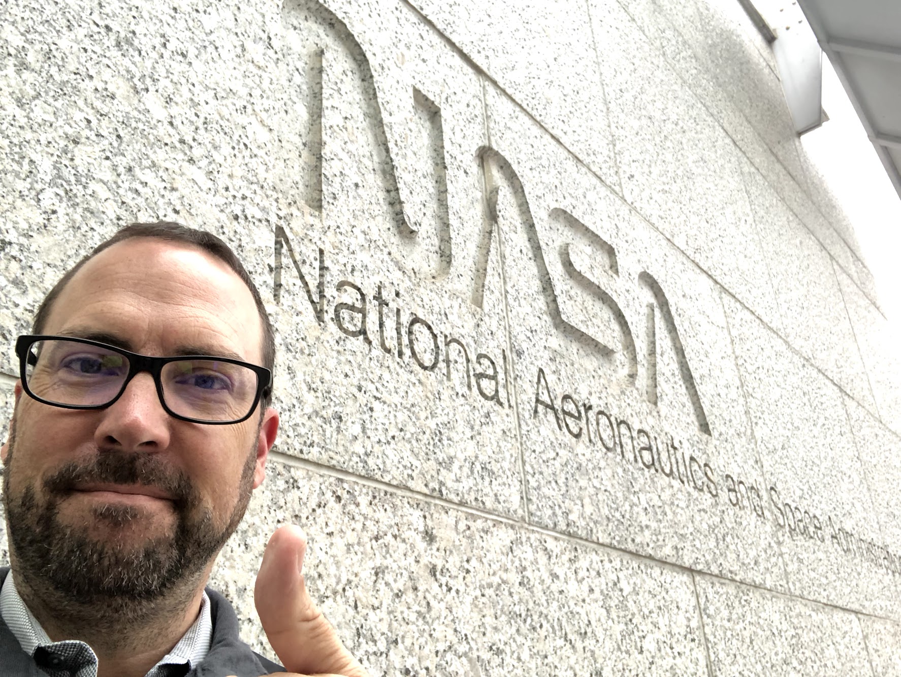 Myself in front of the "worm" logo on NASA HQ